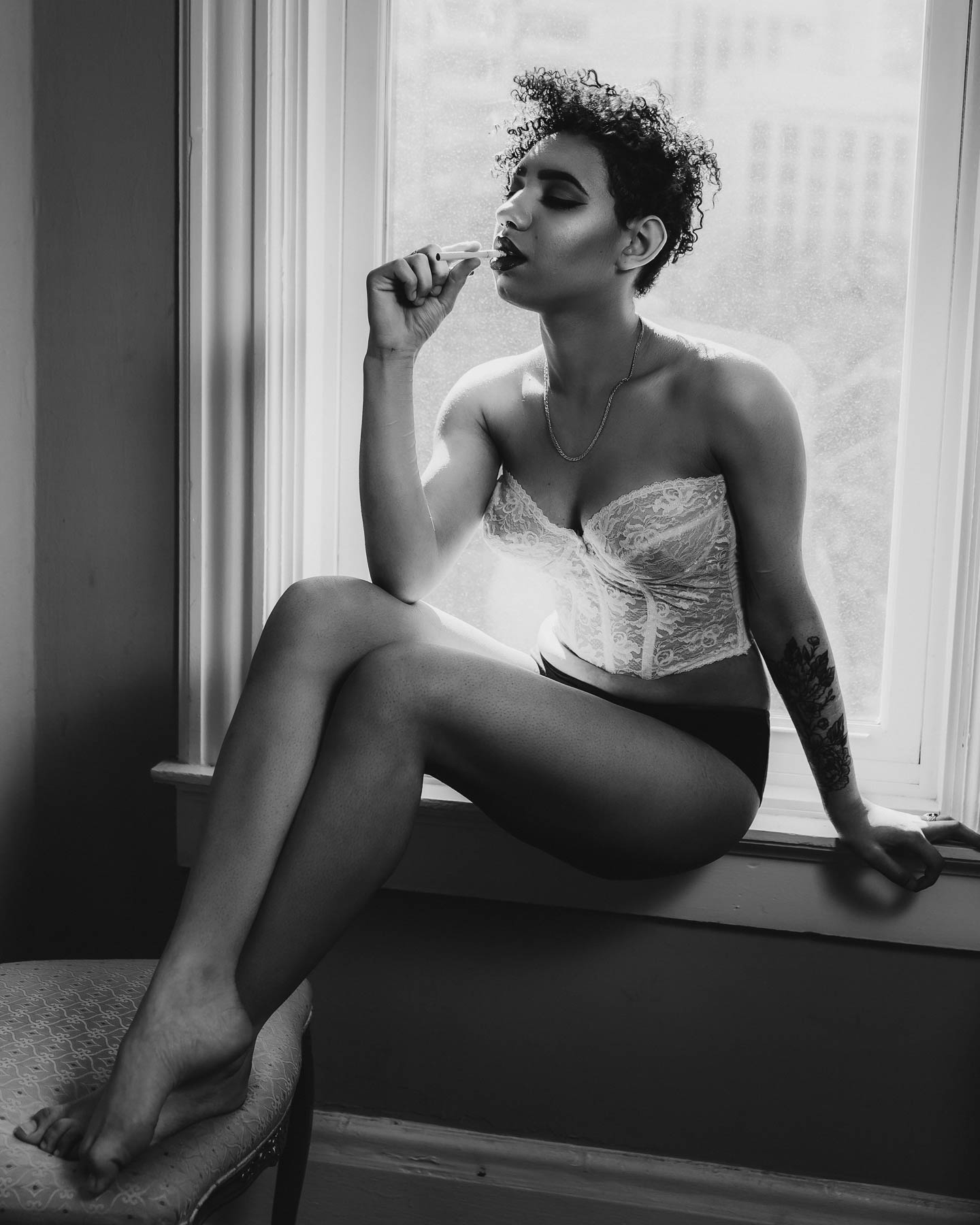 Black and white photography of a woman in lingerie.