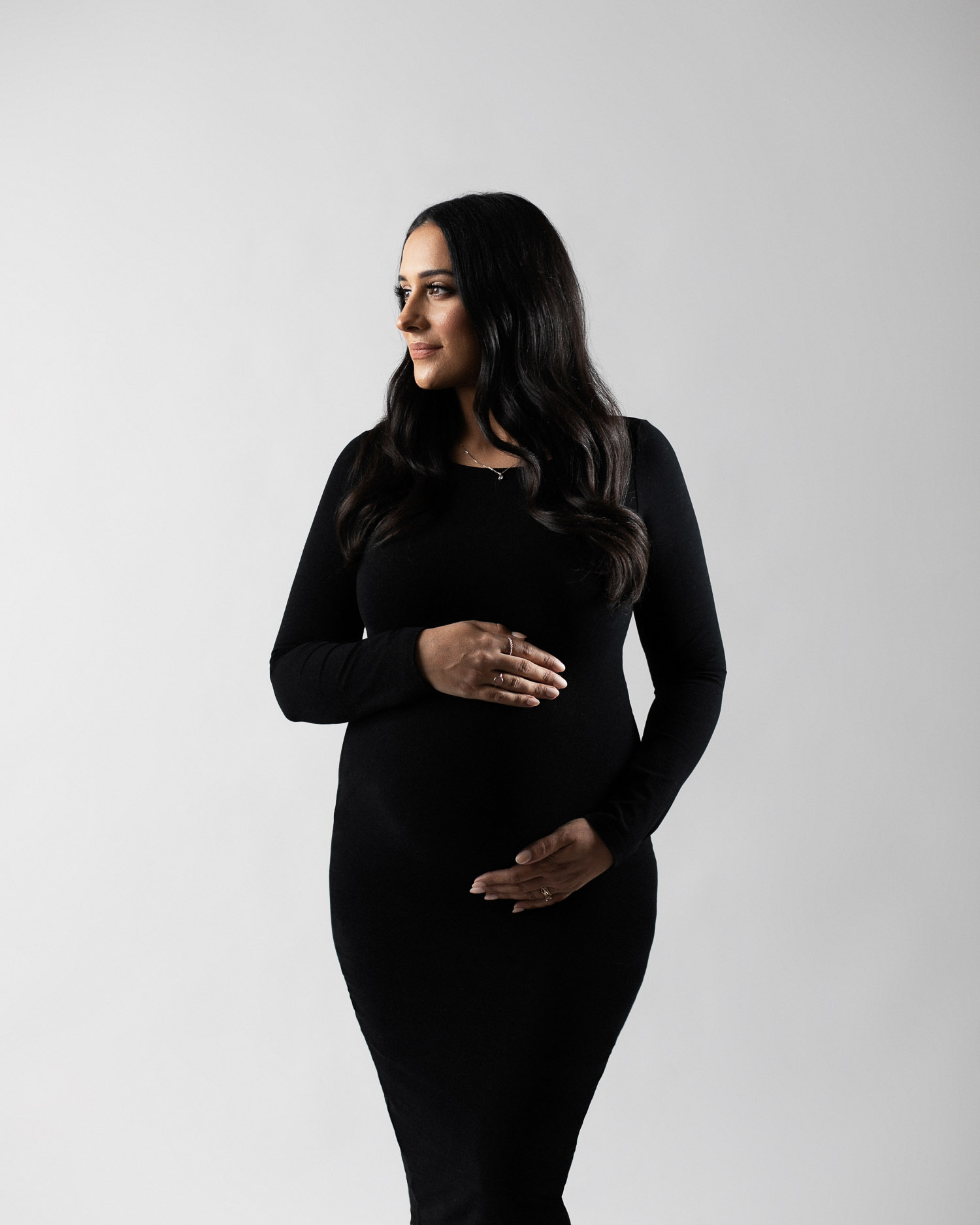 Pregnant woman wearing a black dress.