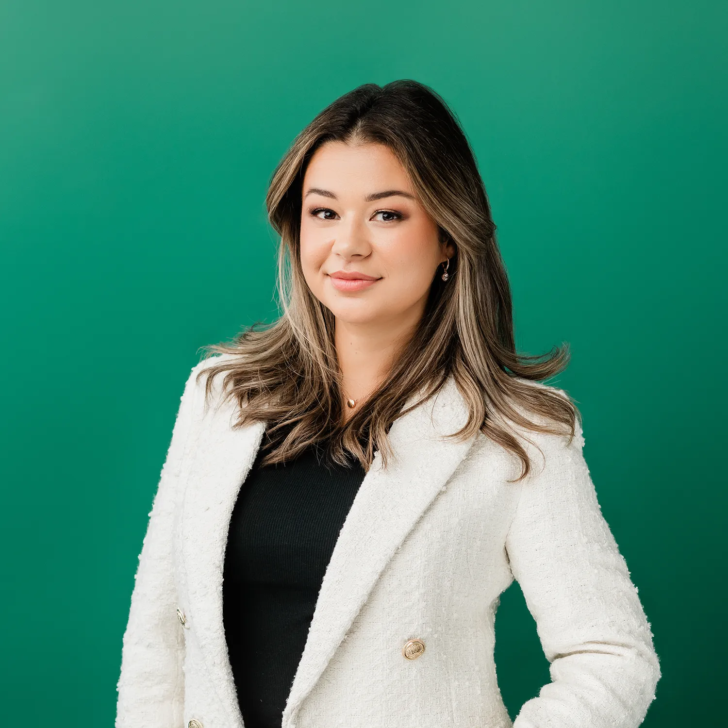 Female headshot against a green backdrop