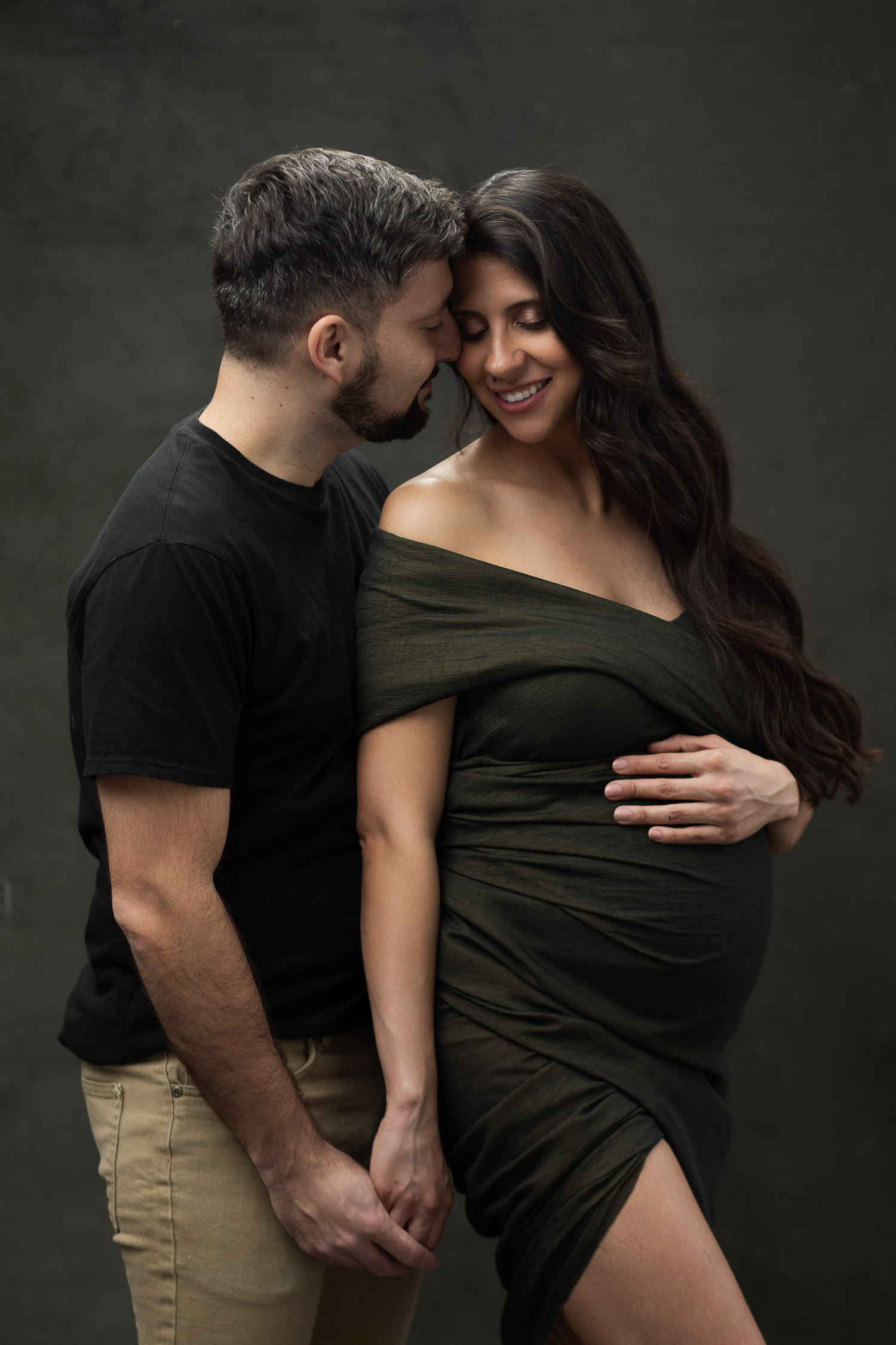 Couple posing for a maternity editorial photoshoot